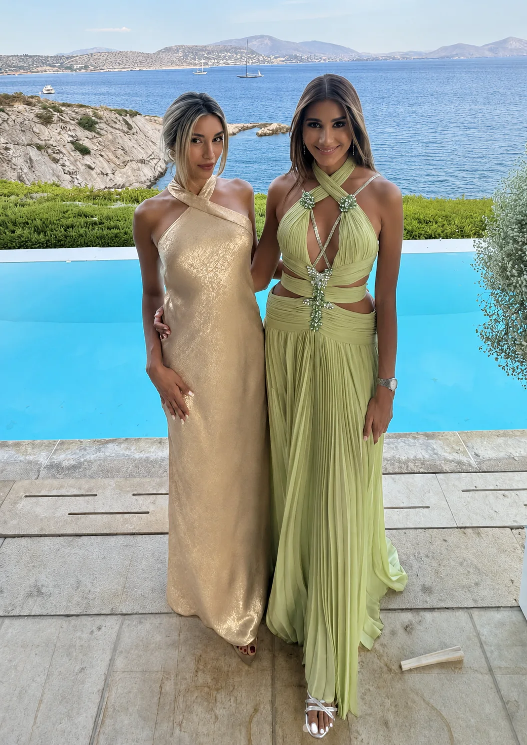 Two clients wearing softly draped champagne and green occasion dresses