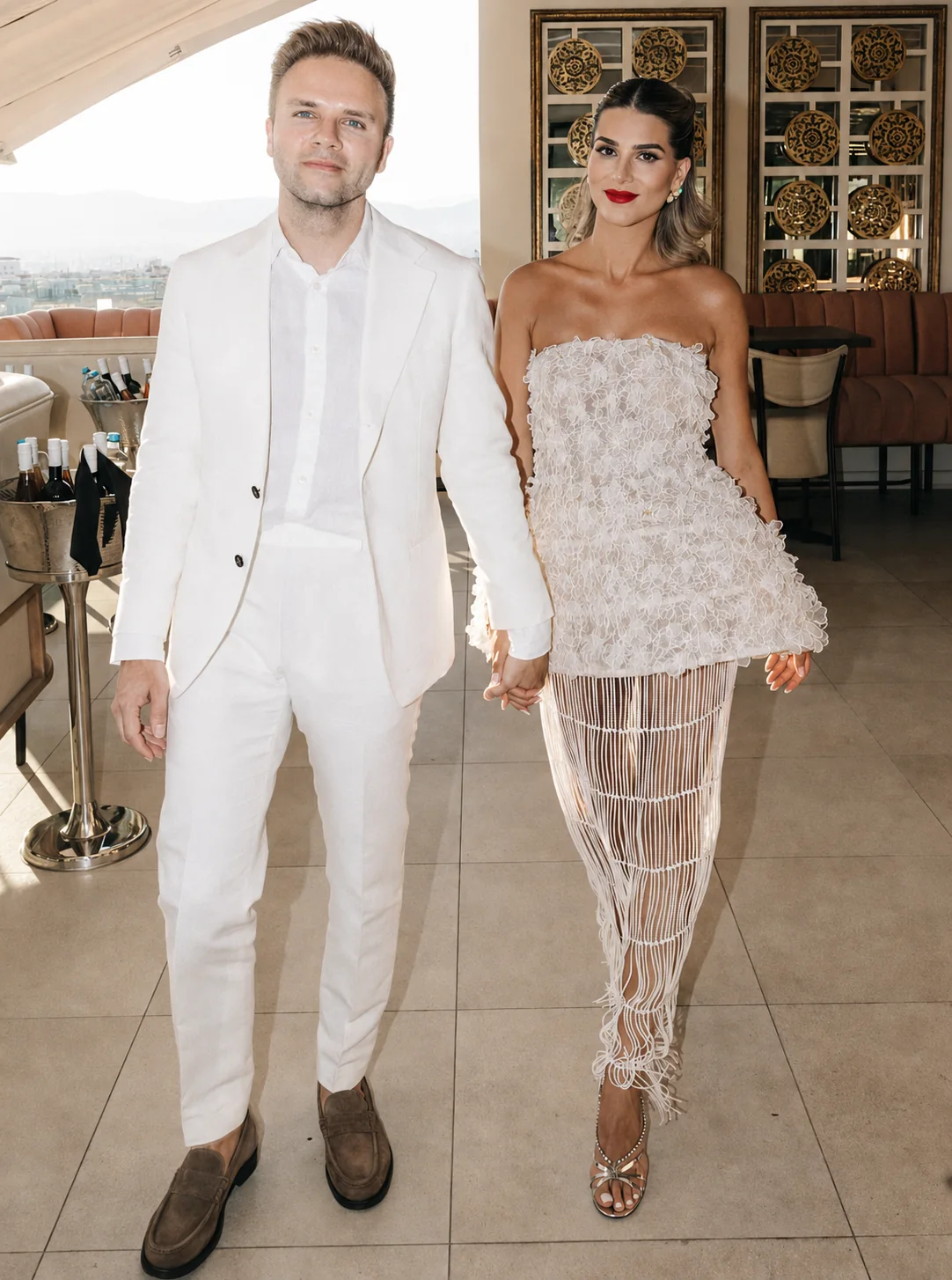 A client wearing a sculptural ivory DORDO occasion look