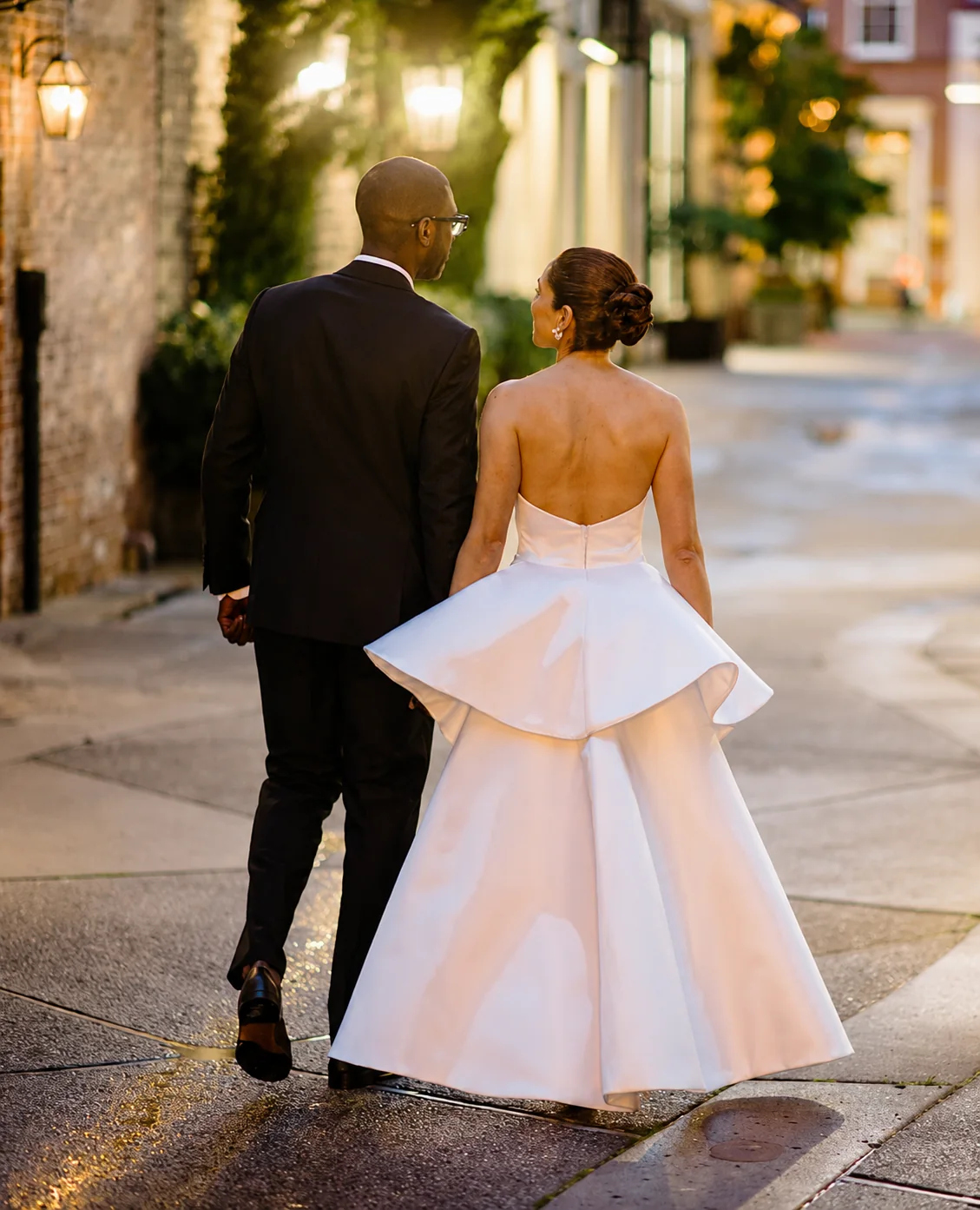 A client walking in a white architectural evening dress