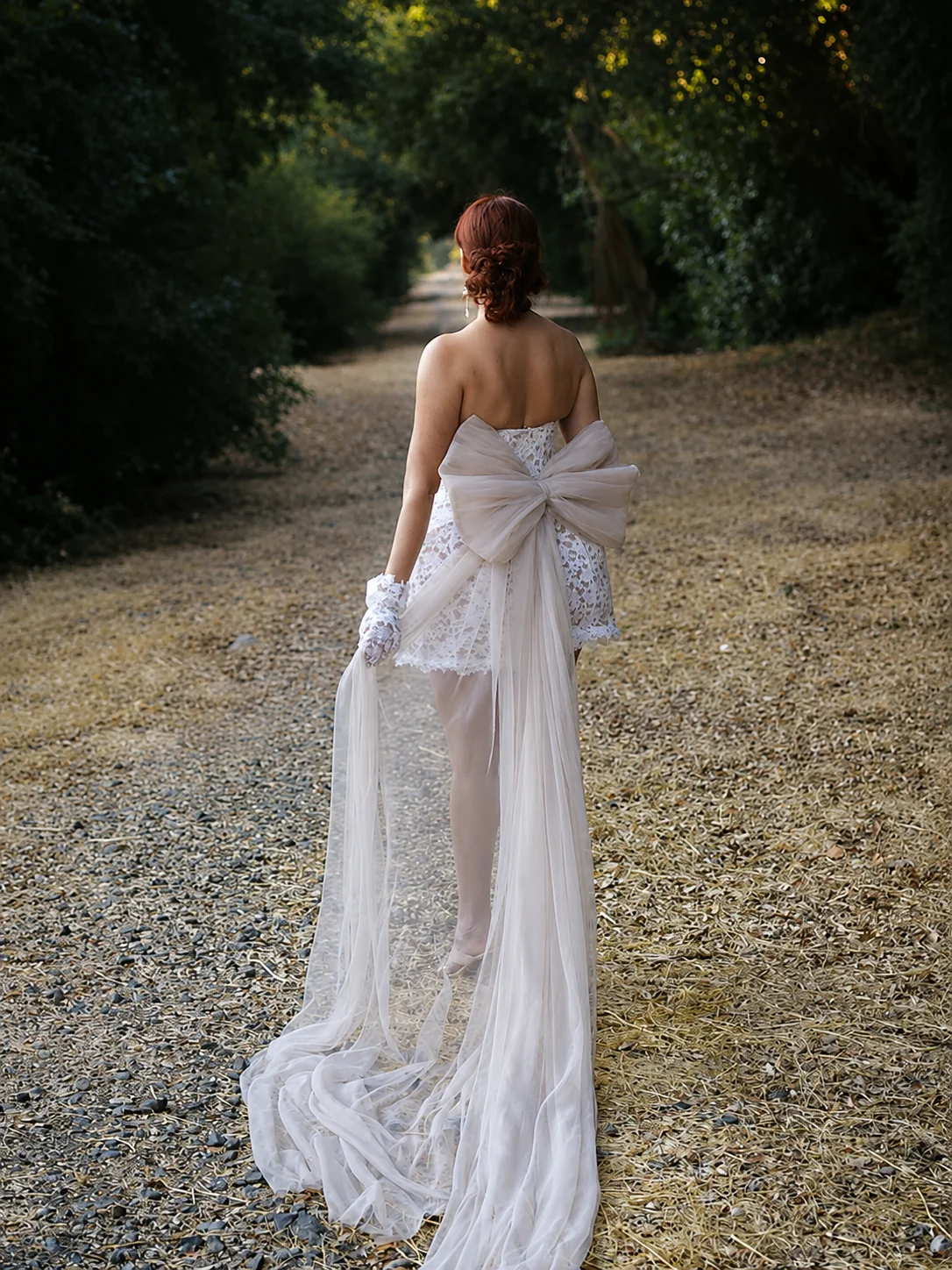 A bride walking outdoors in a flowing DORDO gown
